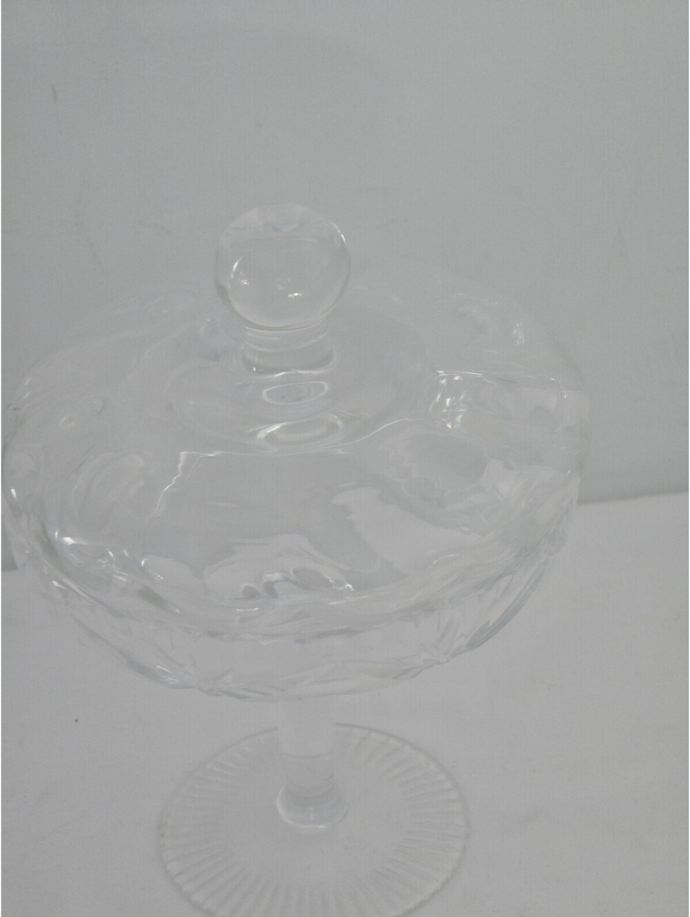 vintage clear crystal pedestal candy dish with a matching lidded cover.